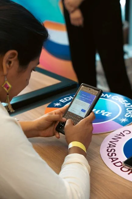 Womans hand writing the word audience on a whiteboard, with arrows.