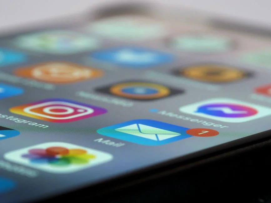 Close-up view of a hand gripping a smartphone, with the hashtag #micropreneur displayed on the screen, illustrating entrepreneurship.